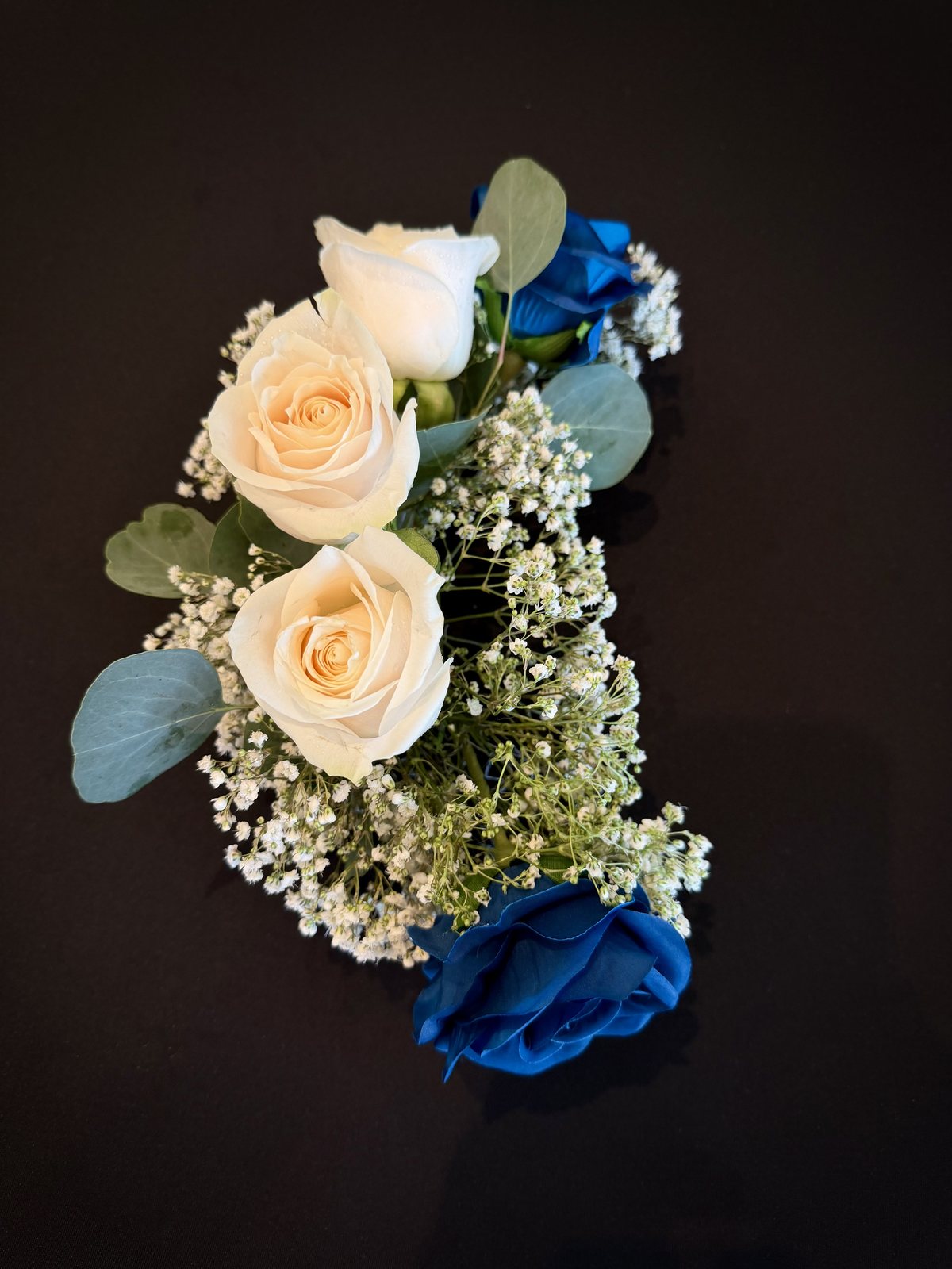 Wedding florals — cream and blue roses, baby's breath and eucalyptus — Four Points by Sheraton Kelowna reception