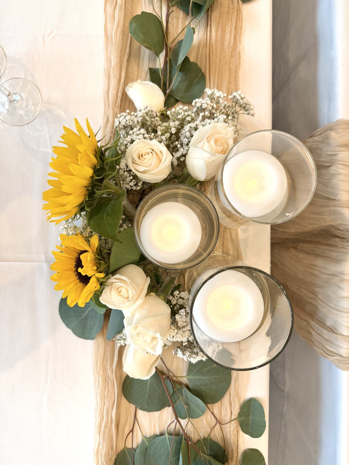 Sunflower, white rose and baby's breath centrepiece with floating candles — Four Points by Sheraton Kelowna wedding reception