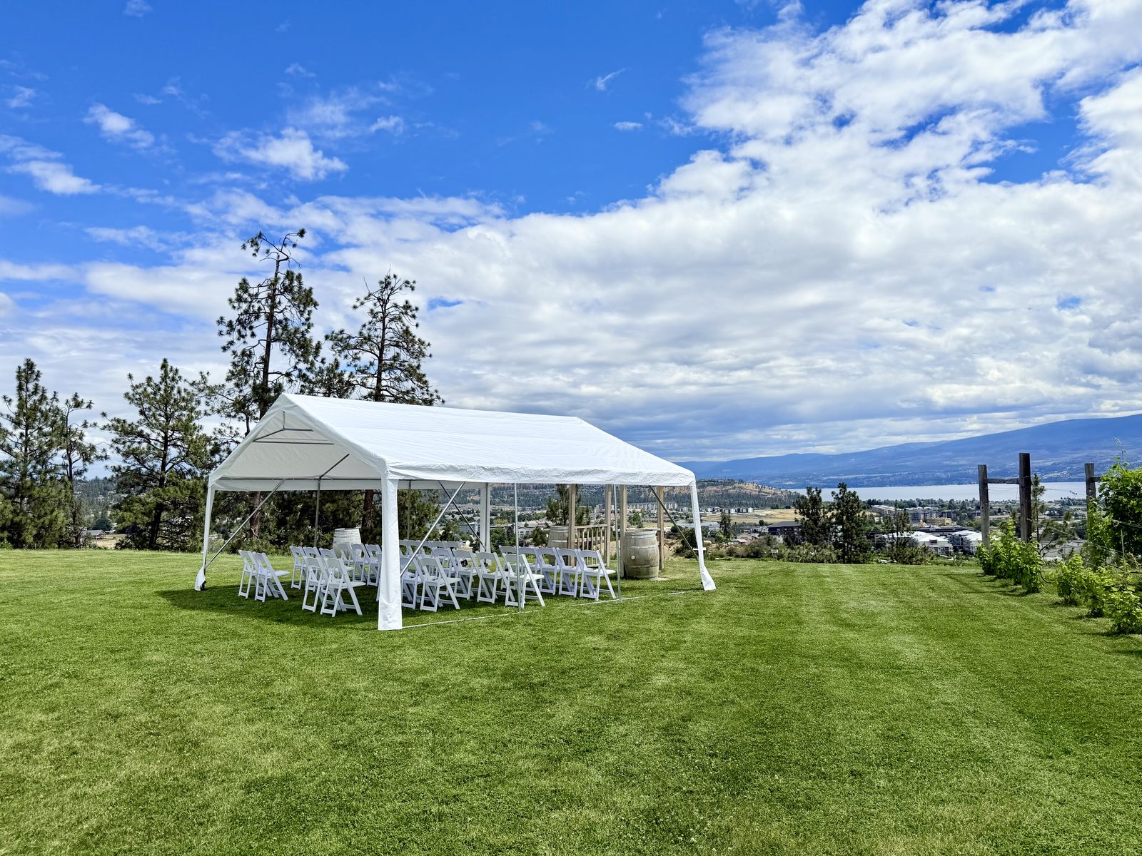 White frame tent set for a winery wedding ceremony at Off The Grid, West Kelowna