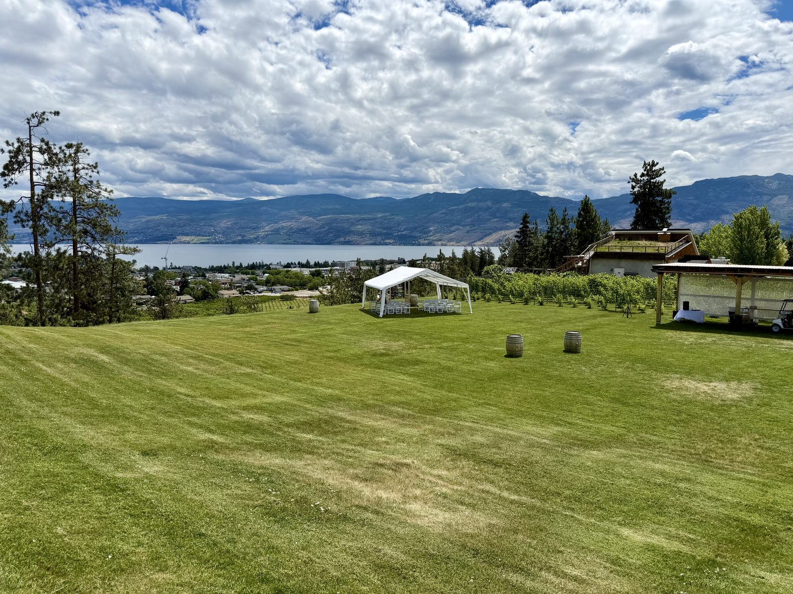 Hillside frame tent wedding with Okanagan Lake and mountain views — Off The Grid Organic Winery