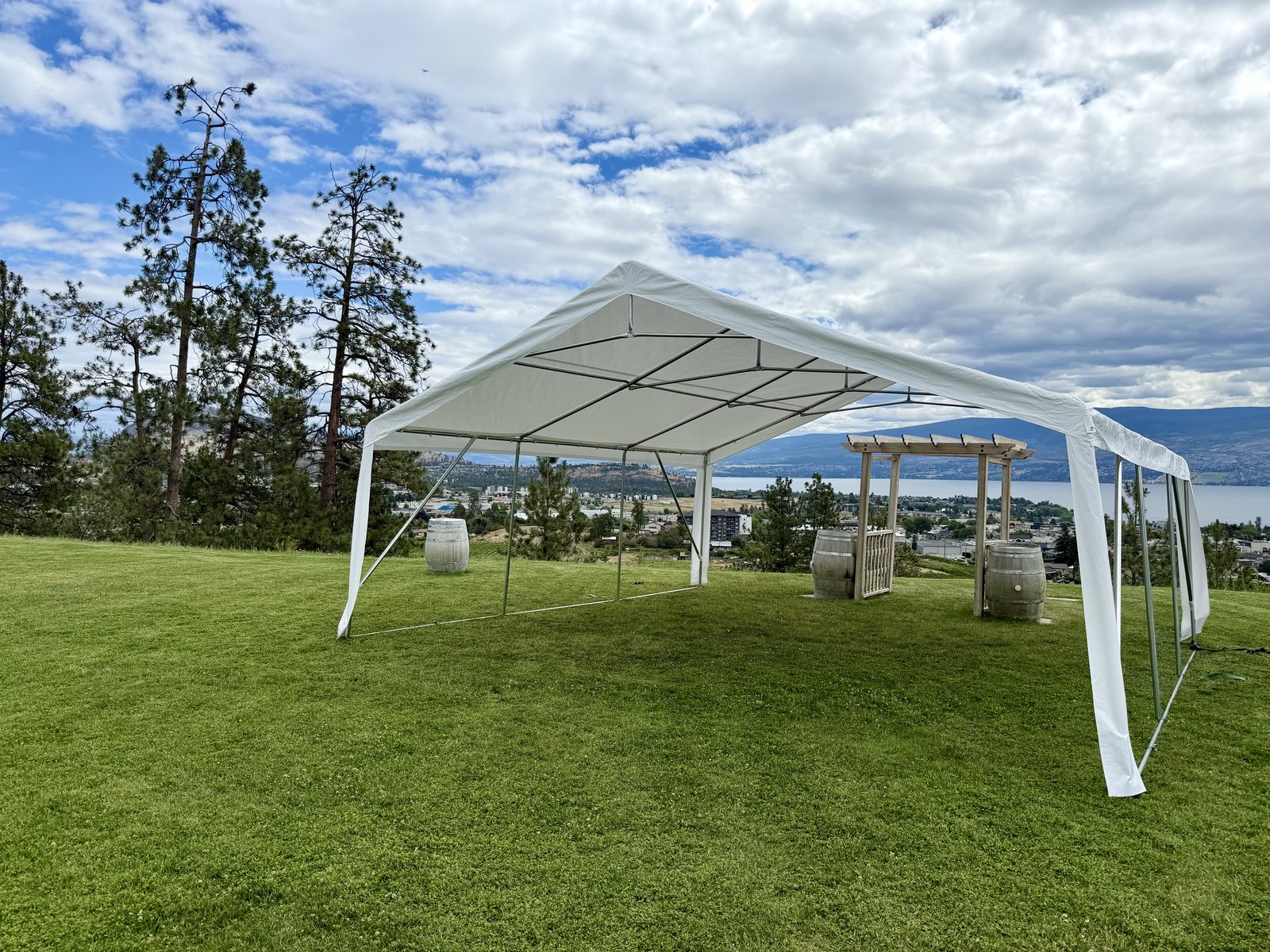 Frame tent winery wedding beside the vineyard rows at Off The Grid, West Kelowna